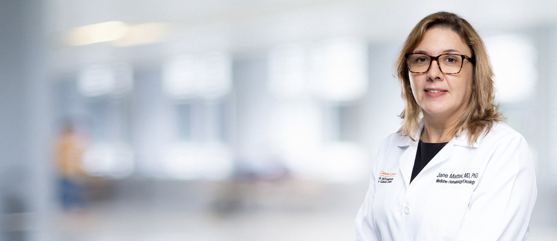 Dr. Jane Mattei in a white coat, smiling for a photo.