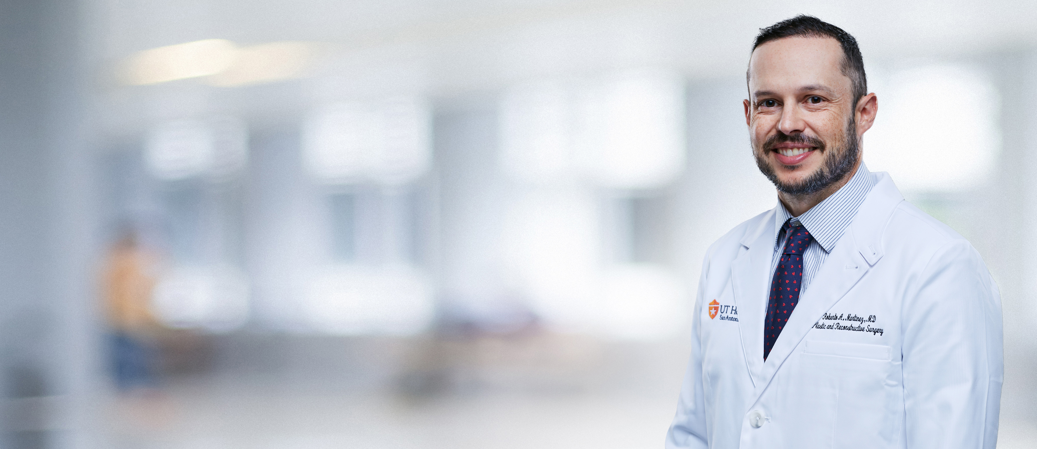 A photo of Dr. Roberto Martinez in his whitecoat