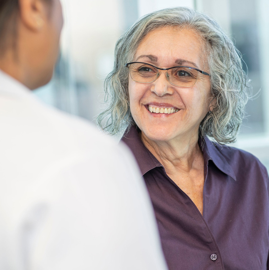 Patient looking up at her doctor and smiling
