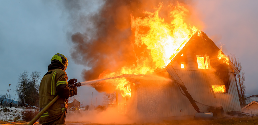 Firefighters extinguishing a house fire