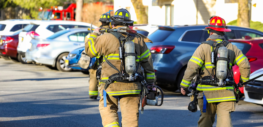 Firefighters walking in a parking lot