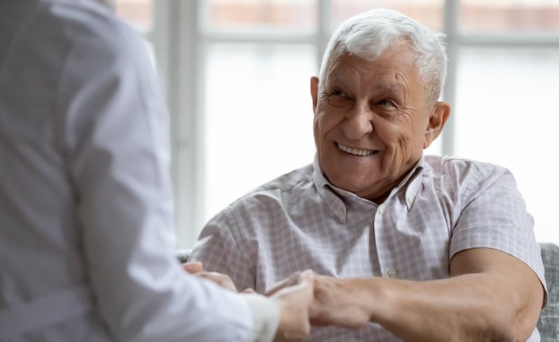 Thermal ablation patient smiling holding hand of physician
